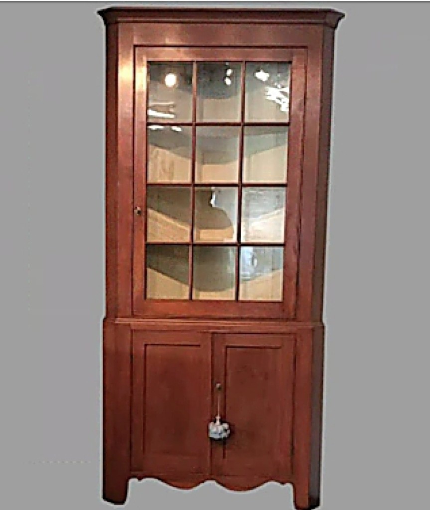 Edwin C. Skinner, specializing in Eighteenth and Nineteenth Century American and European antiques was offering this early Nineteenth Century American corner cupboard, 87 inches high. From the mid-Atlantic region, the two-piece cherry cupboard has a 12-pane single upper door and twin recessed panel doors below. It was, according to Skinner, “a classic design, well proportioned, white pine secondary wood, structurally sound, never any insect infestation.”