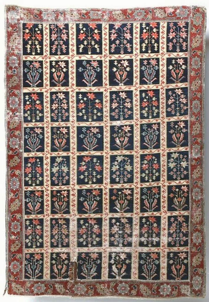 This Eighteenth Century garden carpet of wool on cotton measured 77 by 53 inches and sold for $17,700. The border is later, but the pattern earns its moniker for the series of flora panels.