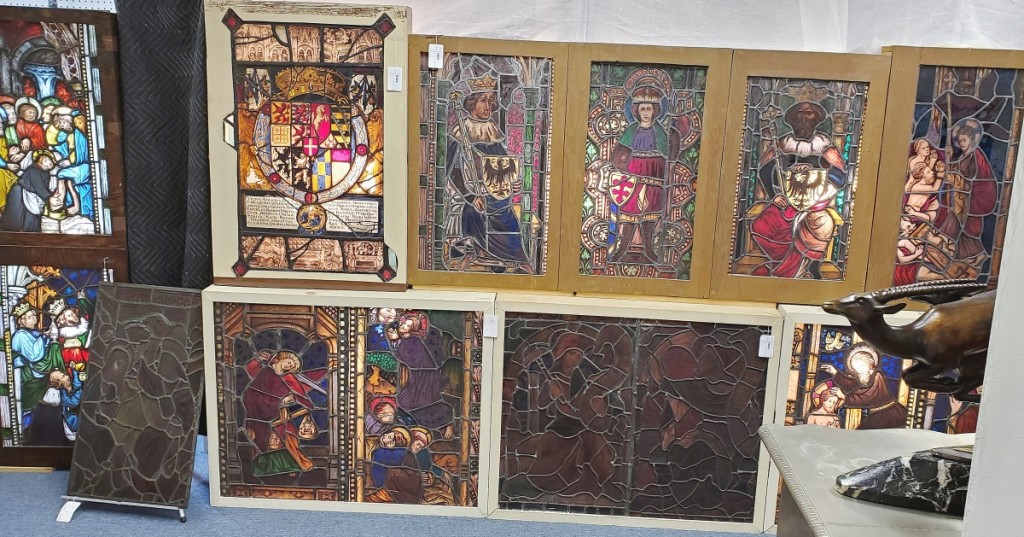 The first dozen lots of the Johnson estate collection featured stained glass window panels, many of which are included in this exhibition photograph. All told, the dozen lots totaled about $20,000.