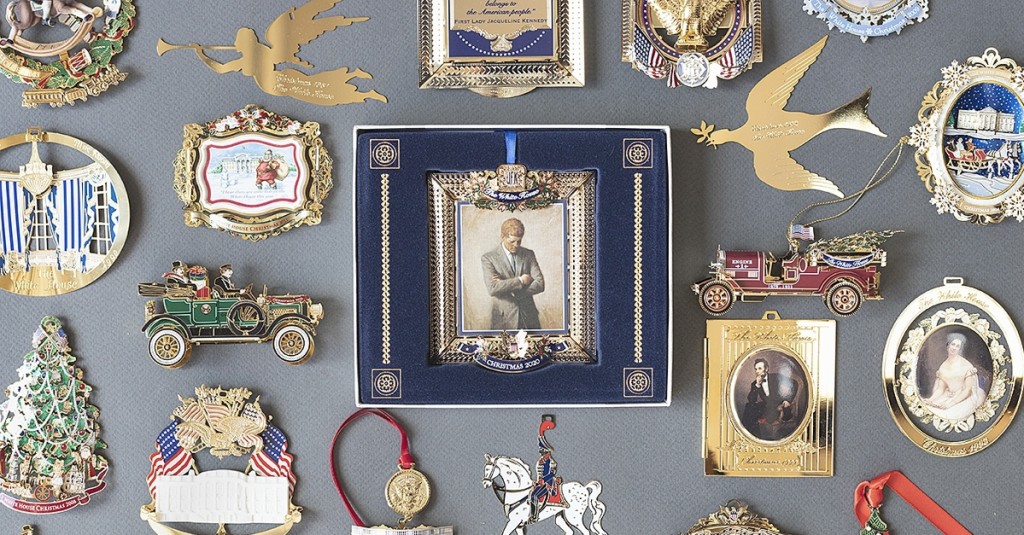 The 2020 ornament (center) features Aaron Shikler’s portrait of a pensive President John F. Kennedy. It is shown surrounded by official ornaments of Christmases past.
