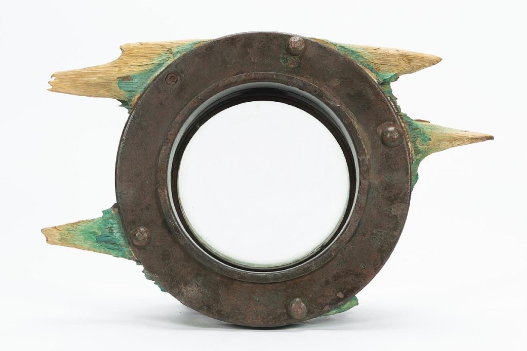 The top lot in the sale of objects salvaged from the wreck of the RMS Carpathia was this salvaged porthole with remnants of its original wooden surround. A buyer in the United States took it for $15,730 ($700/900).