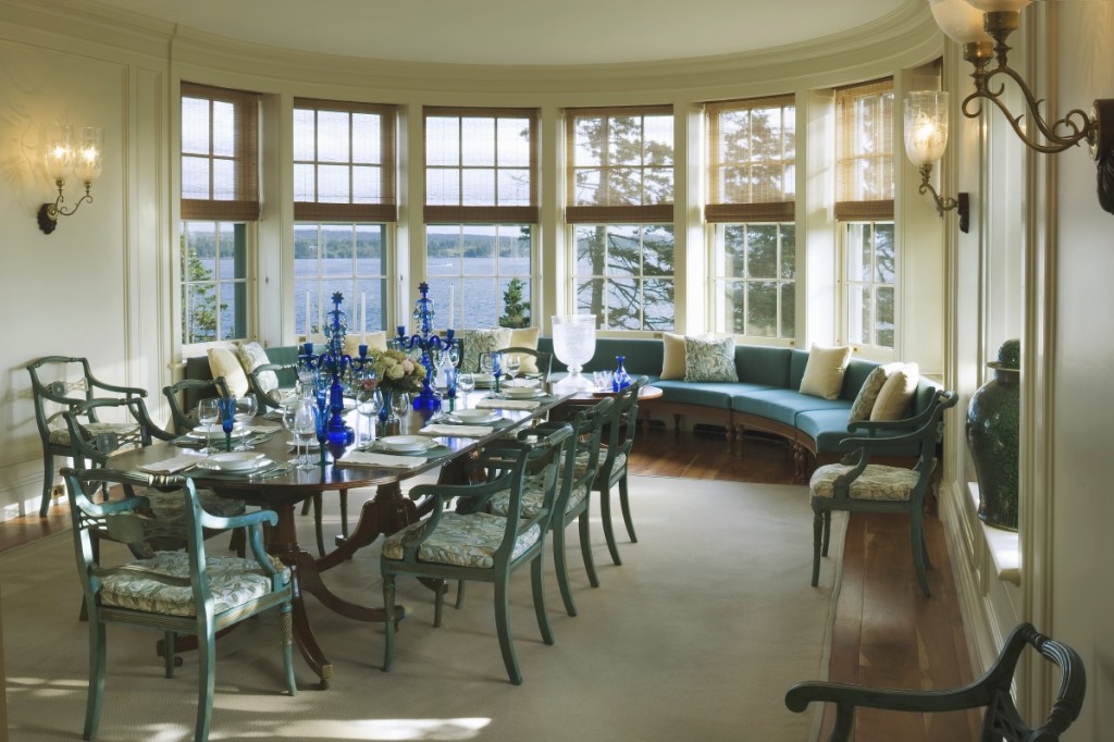 The bay window with a view of the Maine coast gives the room a nautical quality. The curved bench provides a cozy place for a small dinner. Photo Jonathan Wallen.