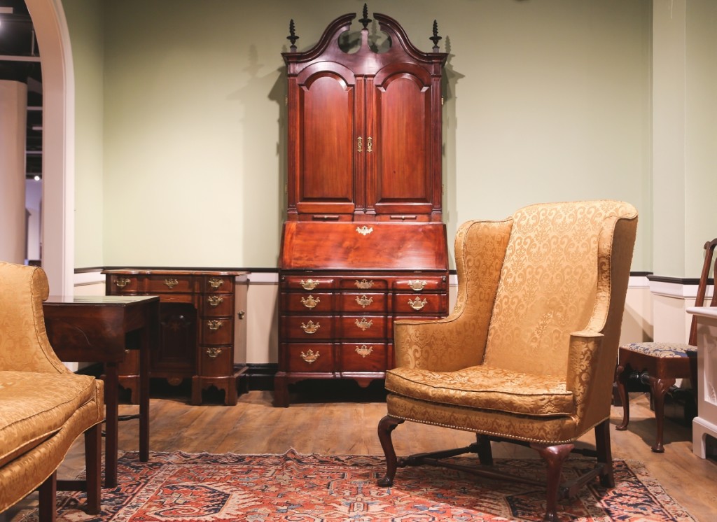 A circa 1750 Queen Anne wing chair, once in the collection of the Museum of the City of New York, sits before a Boston Queen Anne secretary of about the same age. The secretary is among a small group of first-generation blockfronts out of that city.