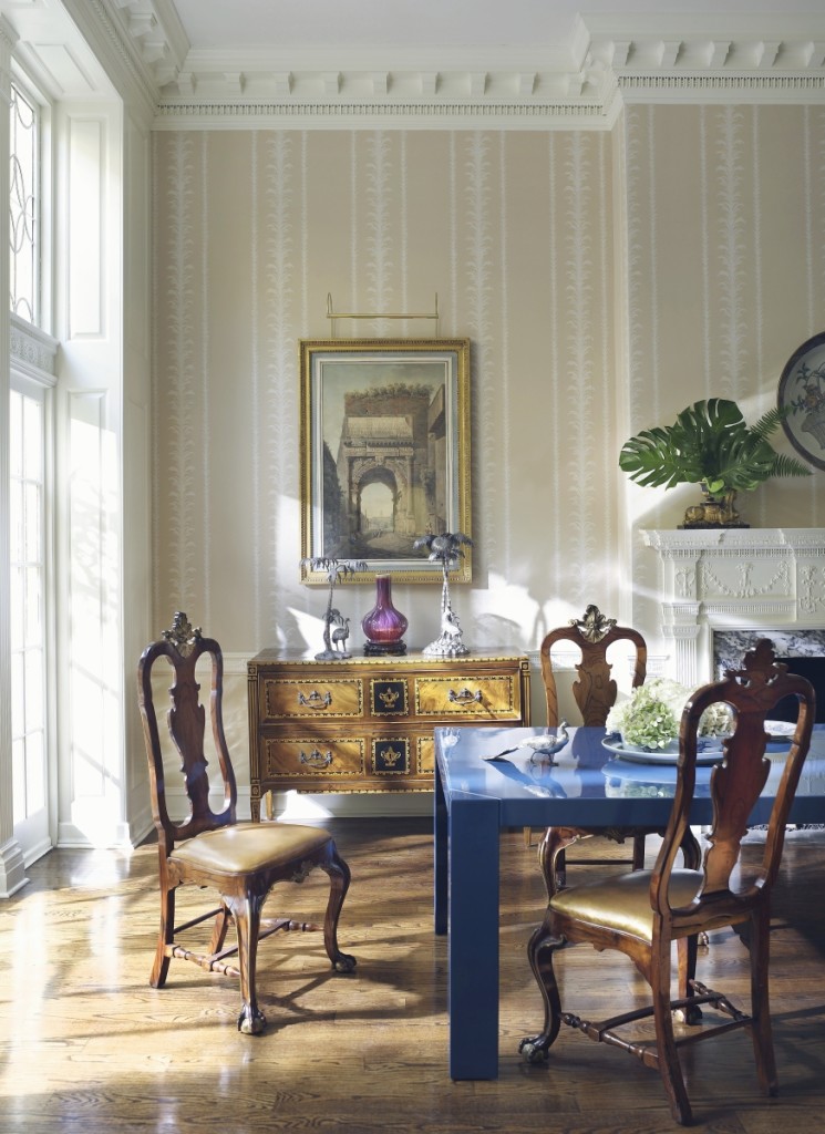 A modern Parsons-style dining table amid a collection of antique furniture creates a contemporary design contrast. Photo Pieter Estersohn.