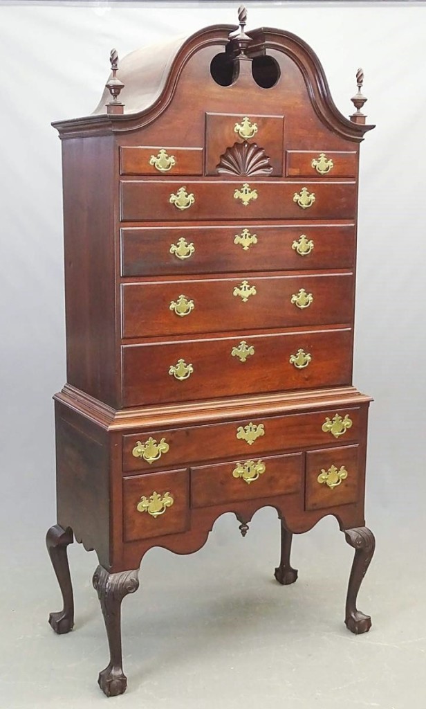 This Eighteenth Century Boston Chippendale mahogany highboy went on to bring $5,900. It had a bonnet top and broken arch with three flame finials.
