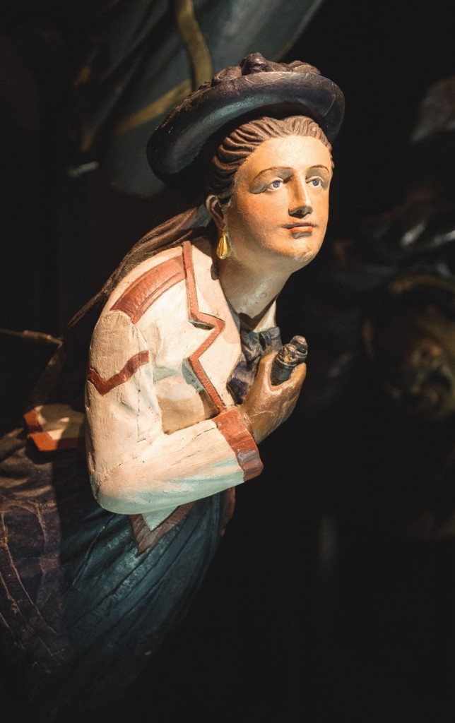 Figurehead of a woman with binoculars.