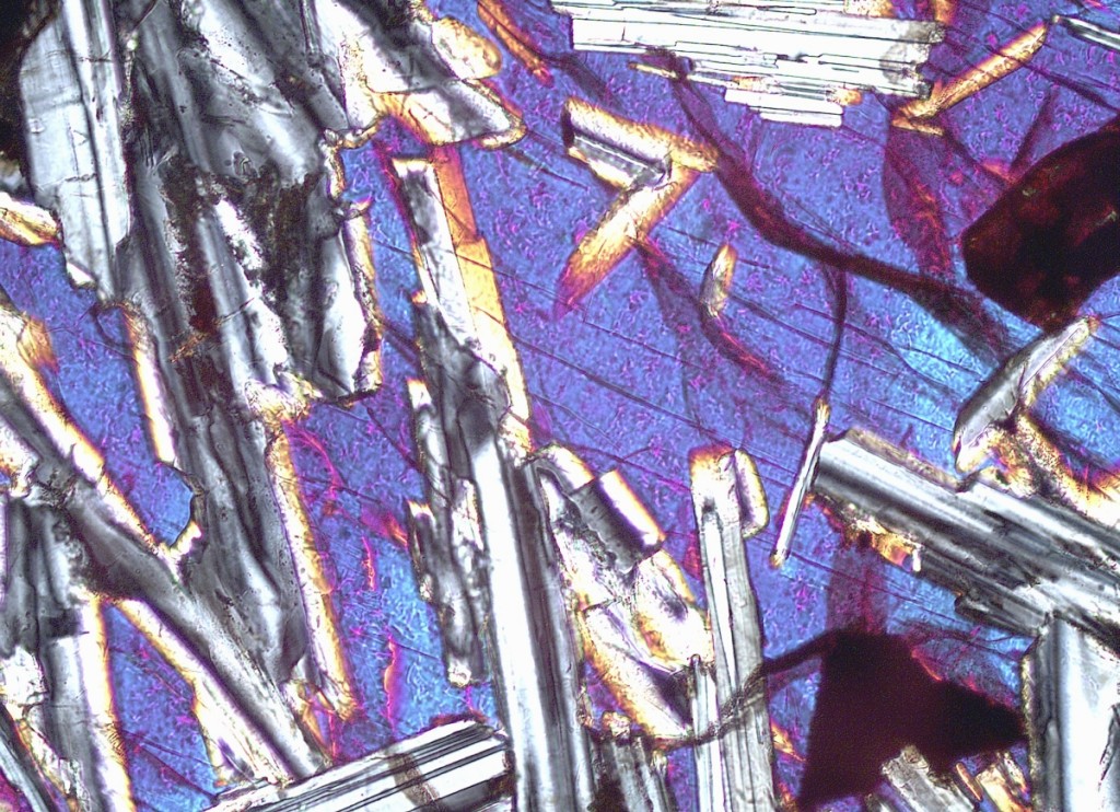 As seen under a microscope, a basalt inclusion in a ceramic tile from the first half of Sixth Century BCE, from Gordion, in present-day Turkey. Photo: Janelle Sadarananda and Brigitte Keslinke. SAM 1954-1-128.