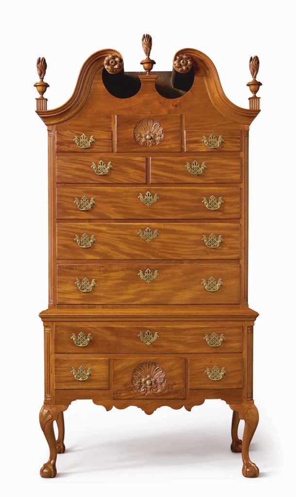 A Chippendale carved and figured mahogany bonnet-top high chest of drawers, circa 1760, case attributed to William Wayne (w. 1756-1786); carving attributed to Nicholas Bernard and Martin Jugiez, Philadelphia, topped its $80,000 high estimate to settle at $107,100. — Important Americana Furniture and Folk Art