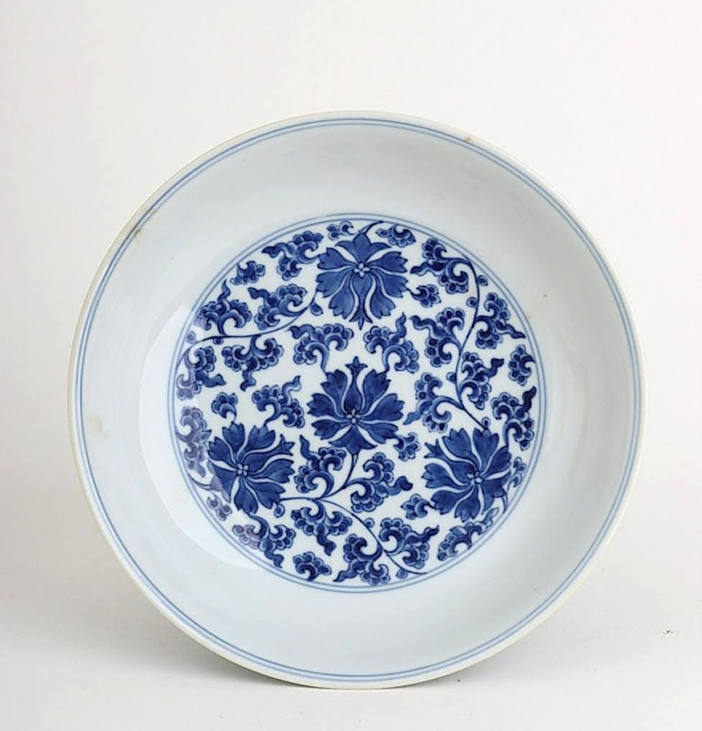 This blue and white porcelain bowl decorated with floral motifs in both basin and outside, with a $100/200 estimate, brought $9,920.