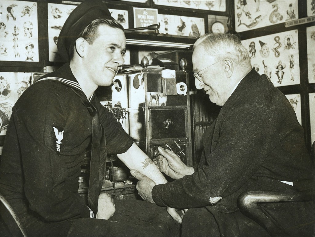 Edward “Dad” Liberty tattooing a young sailor, Boston, 1942. Courtesy of Derin Bray.