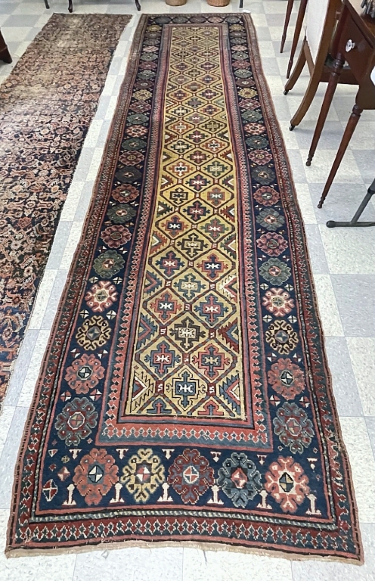 A handmade Oriental runner rug, 42 inches wide by 13 feet 4 inches long, exhibited some wear and fading but was in overall good shape. It sold for $5,930.