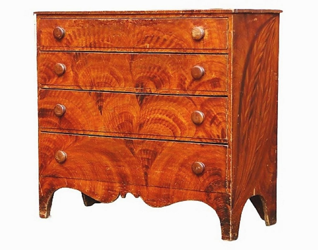 Fetching $4,125 was an early grain-painted chest of drawers, circa 1820, a classic example of the “high style” of cabinet maker Thomas Matteson of South Shaftsbury, Vt.