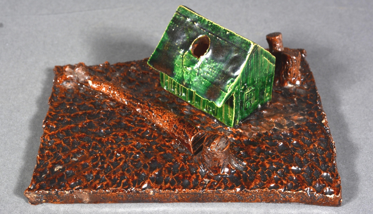 The sale’s leader was found in George Ohr’s cabin inkwell, which sold for $4,875. The cabin inkwell was a standard form for Ohr and others are known in variations of trees and glazes.
