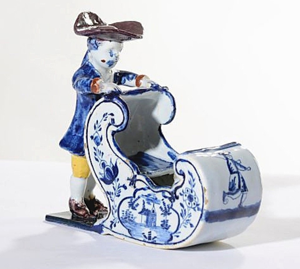 Delftware figure of a man pushing a sleigh, circa 1770, height 5½ inches. Aronson of Amsterdam, The Netherlands.