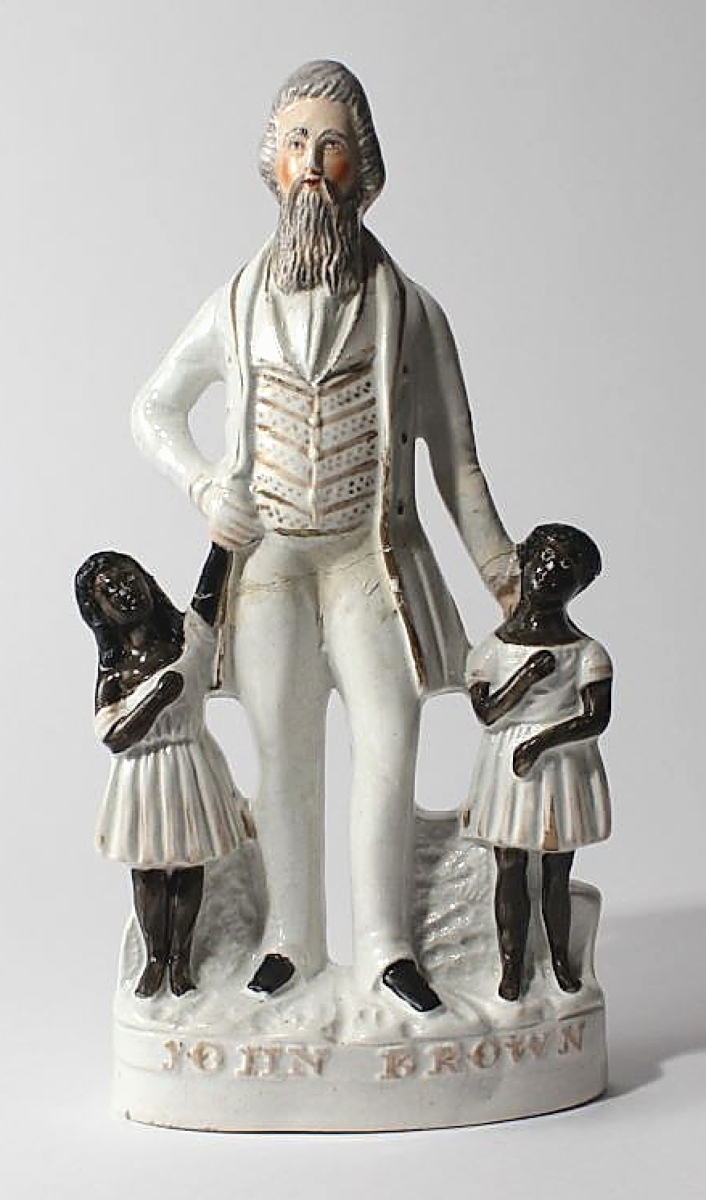 Staffordshire figure of John Brown with two Black children, England, circa 1850s. Porcelain.