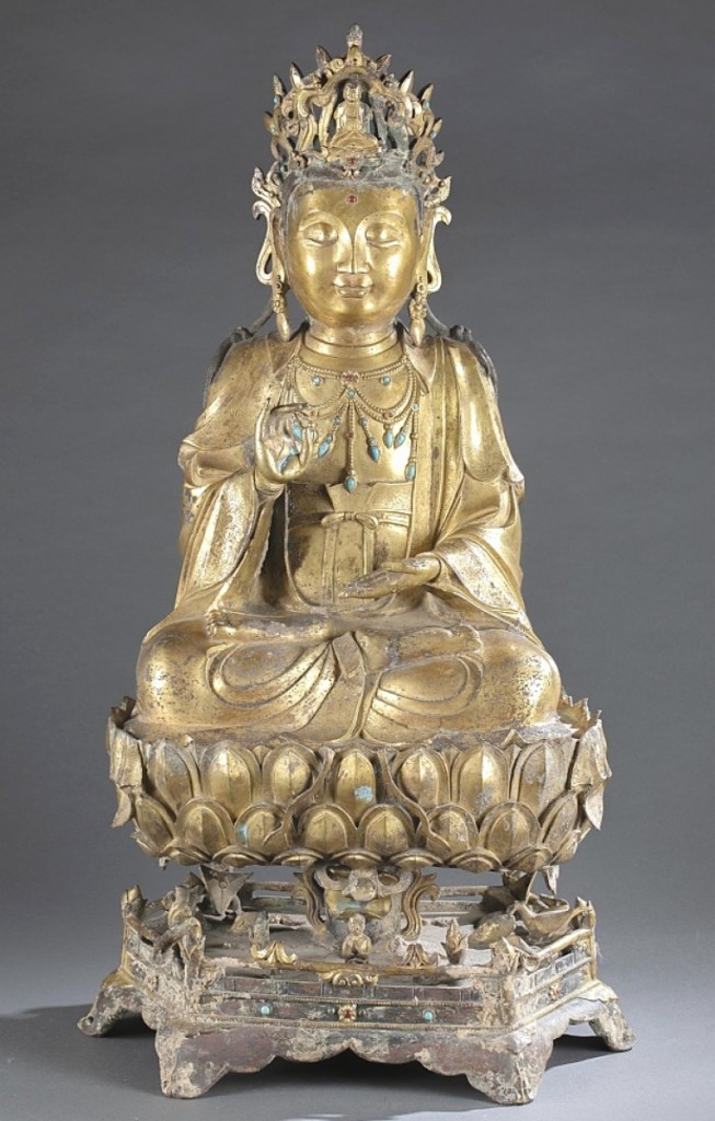 A large Chinese three-piece gilt-bronze guanyin, late Ming/early to mid-Qing dynasty, also performed well, bringing $57,150. Seated in double lotus position (dhyanasana) with the left hand held in dhyana mudra and the right in karana mudra, the guanyin wears a long flowing robe and dhoti bordered with stylized flowers with the chest open draped with an elaborate necklace with hardstone inlay.