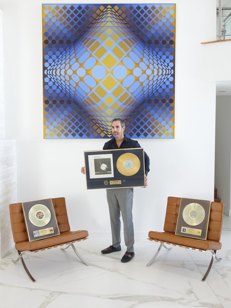 Kodner Galleries president and auctioneer Russ Kodner with the three gold records awarded to Phil Collins, which were being sold by his ex-wife, Orianne Collins.