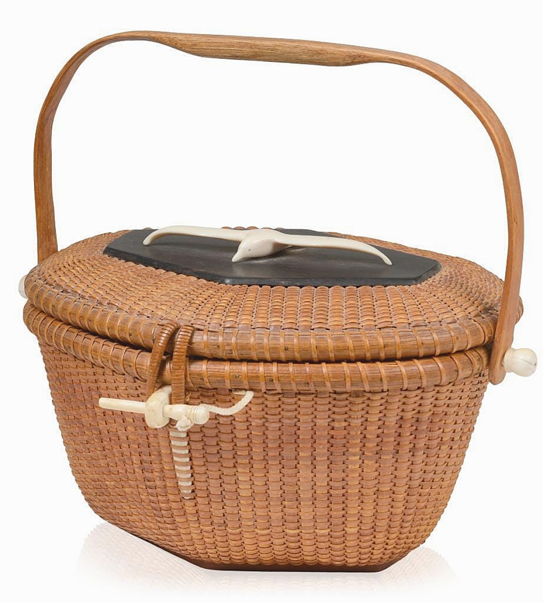 Signed by Jose Formoso Reyes and dated 1956, a Nantucket friendship basket realized $6,728. It had a carved, spread-winged seagull on the cover.