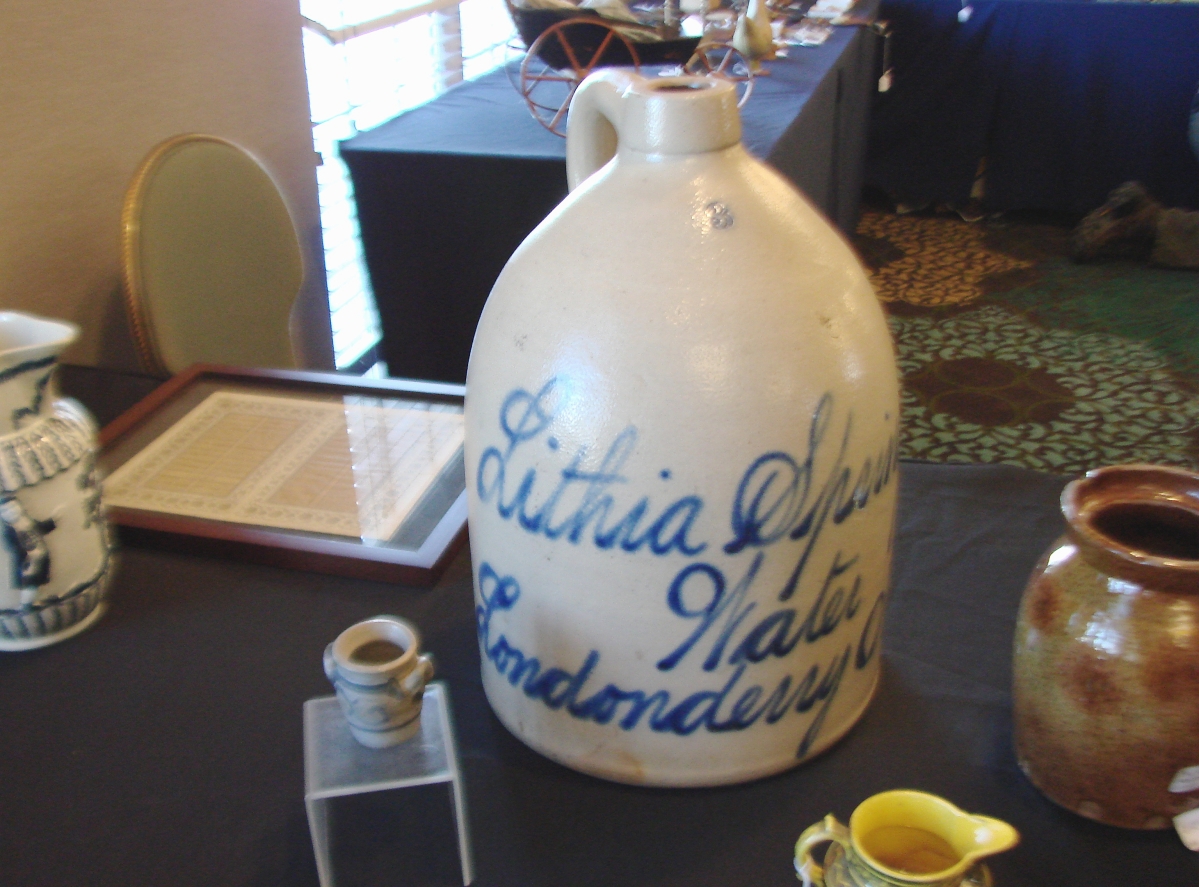 Another of the stoneware jugs on the floor was this large one in the booth of Sam Herrup, Sheffield, Mass. With blue script lettering “Lithia Springs, Londonderry, Ohio,” it was priced $495.