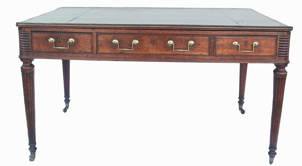 Taking $12,800 was this Regency mahogany writing table with green tooled leather top and tapered, reeded legs.