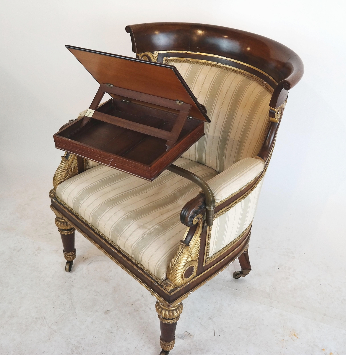 A good sale at $17,220 was this George IV rosewood library chair with removable writing tray and fluted legs.