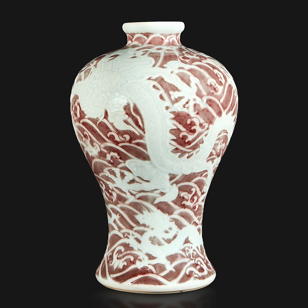 This carved and underglaze red “dragons and waves” vase, Meiping, Yongzheng six-character mark and period brought the top price of the sale. It stood 11-  inches tall and had been in the collection of Sheelah M. Langan (1910-1993); it sold to a phone bidder who prevailed against several other phone bidders, for $2,316,000 ($150/250,000).