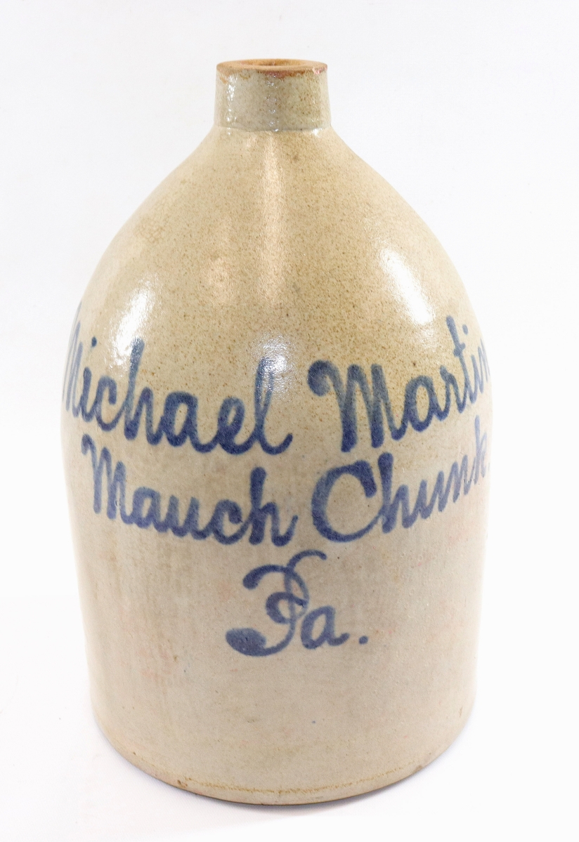 Another 2-gallon blue-decorated stoneware script jug, this one promoting “Michael Martin, Mauch, Chunk, Pa.,” and 14 inches high, also finished at $1,770.