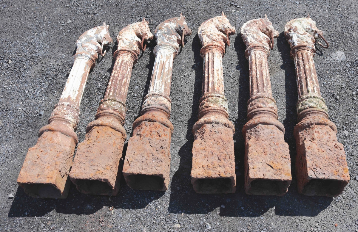 Two groups of matching horse head hitching posts in worn paint, one with six posts and another with five, were top lots in the auction. The lot pictured here settled at $2,583, far above its $400/800 estimate, and the group of five made $2,242.