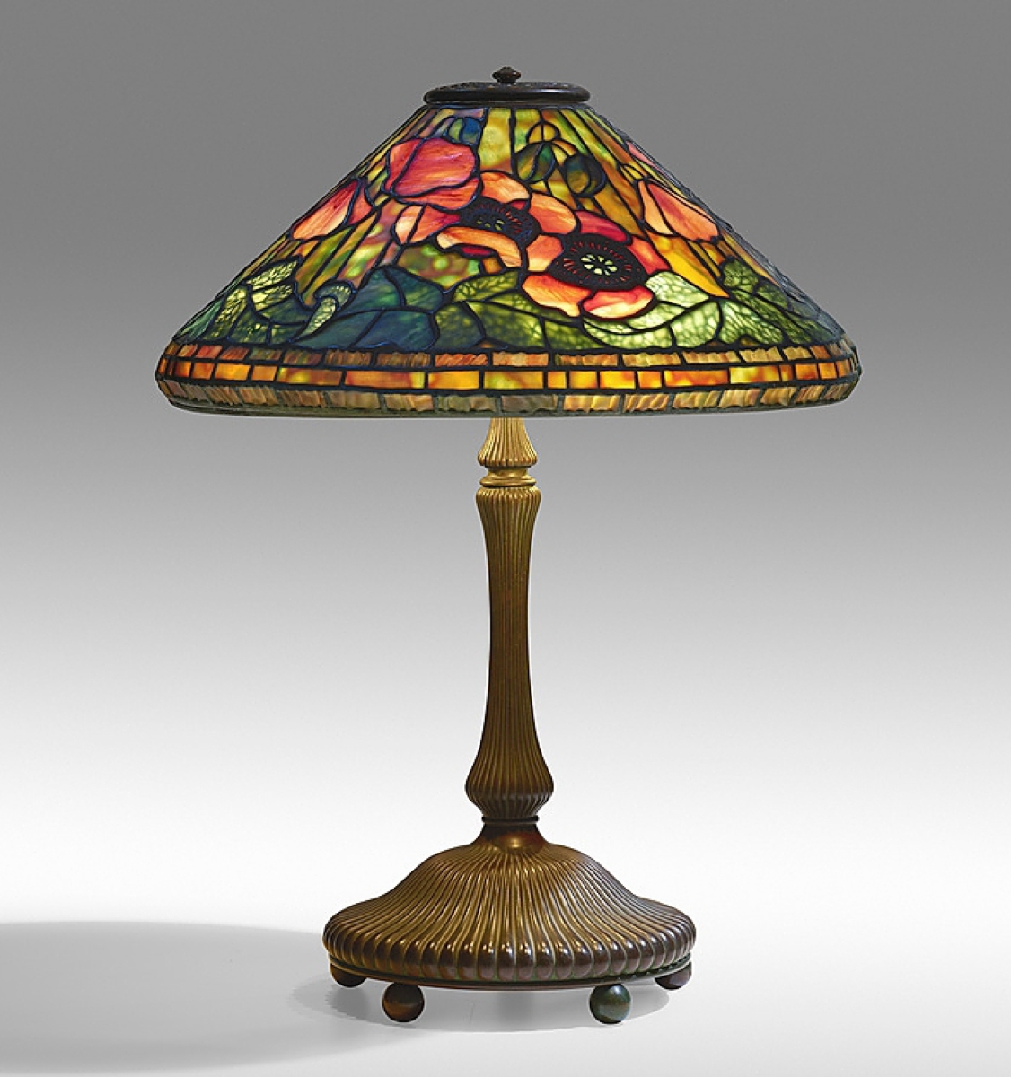 Over doubling estimate was a Tiffany Studios Poppy table lamp that sold for $93,750. The shade sits on a bronze “mushroom” library base.