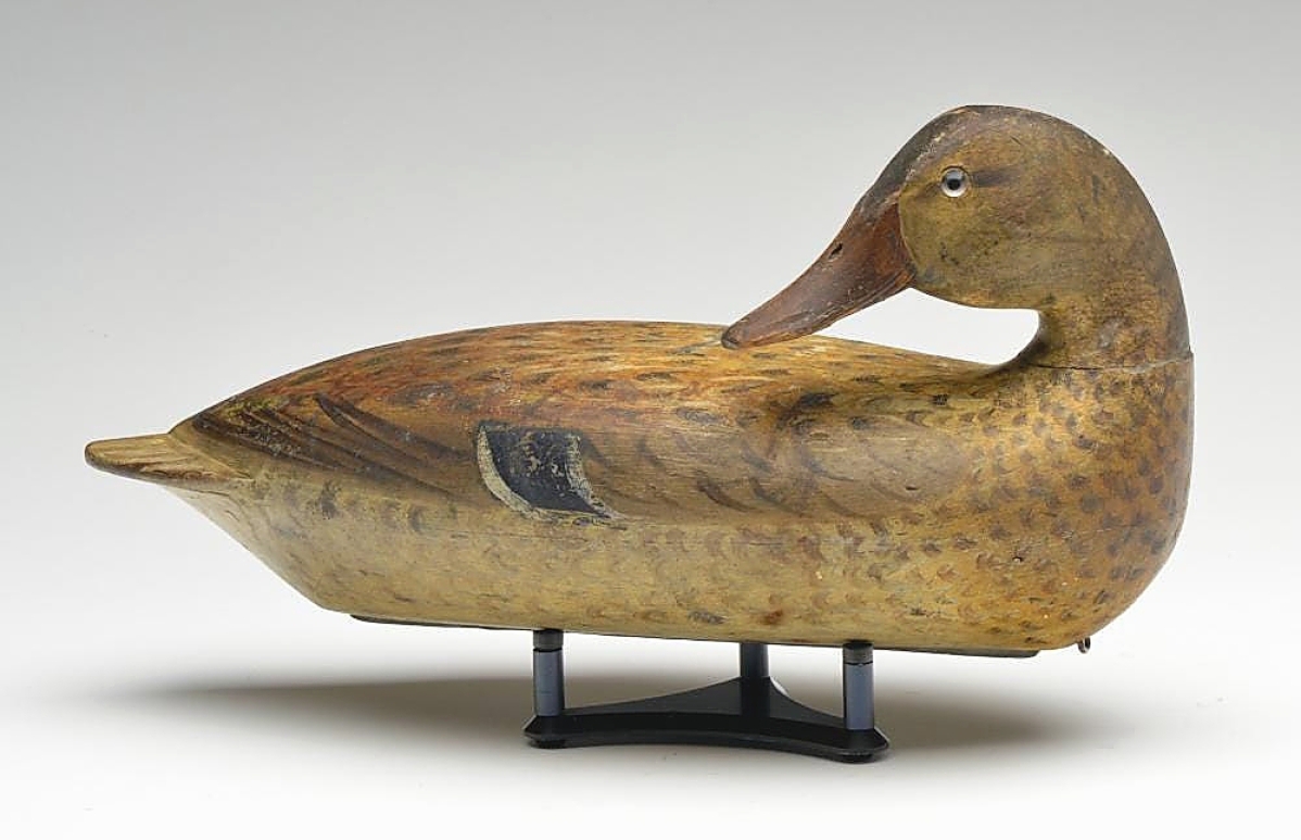 This circa 1900 back-preening mallard hen was carved by Robert Elliston and was one of a small group of decoys found in 2009 by a young couple in the attic of a home they were remodeling. The catalog devotes four pages to this story, and this decoy was sold for $84,000.
