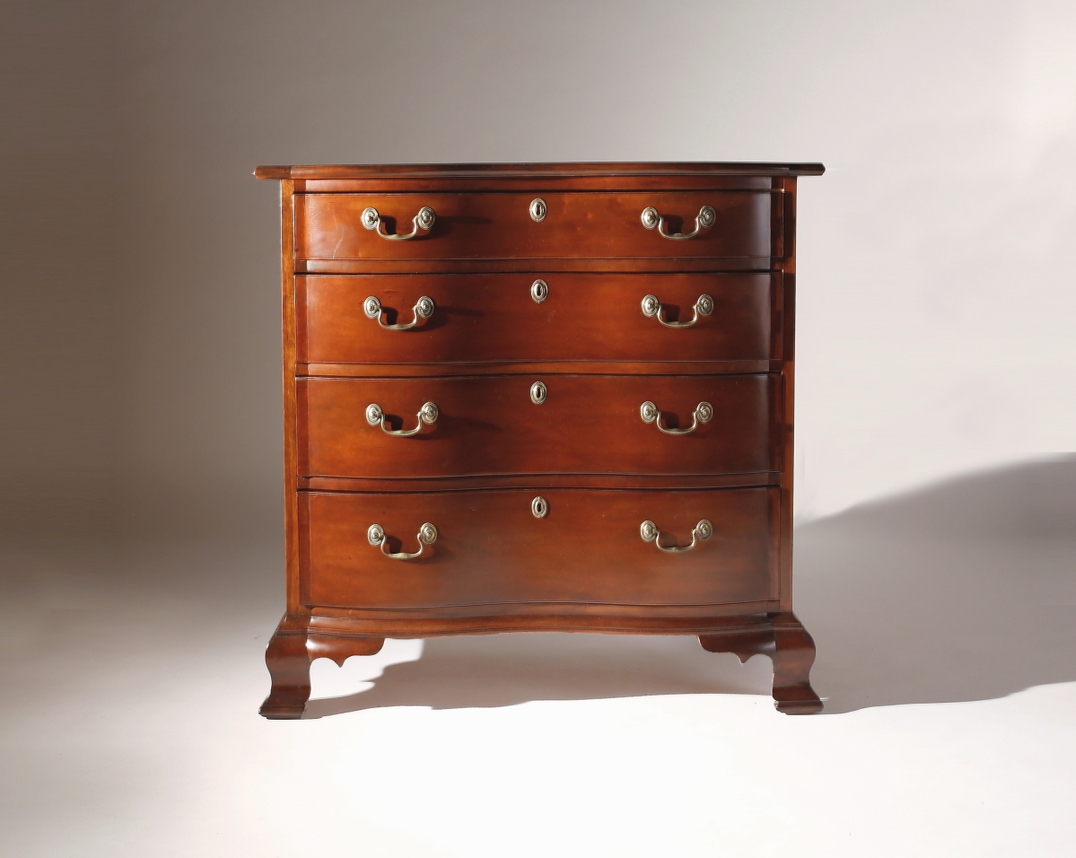 Nathan Liverant and Son had this Chippendale cherry oxbow chest of unusually small size. It was attributed to the Chapin school of East Windsor or Hartford, Conn., and featured applied quadrant block ogee bracket feet. Colchester, Conn.