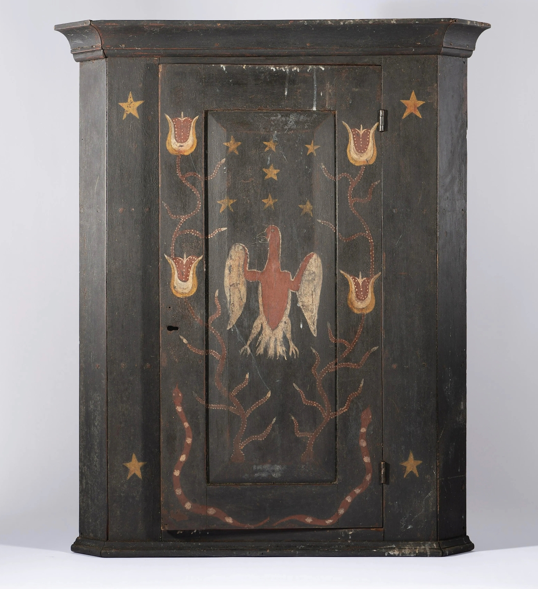 At $5,535 was this Tennessee painted hanging corner cupboard featuring decorations of a tulip, eagle, snakes and stars. It was once in the collection of Dr Mervyn King.