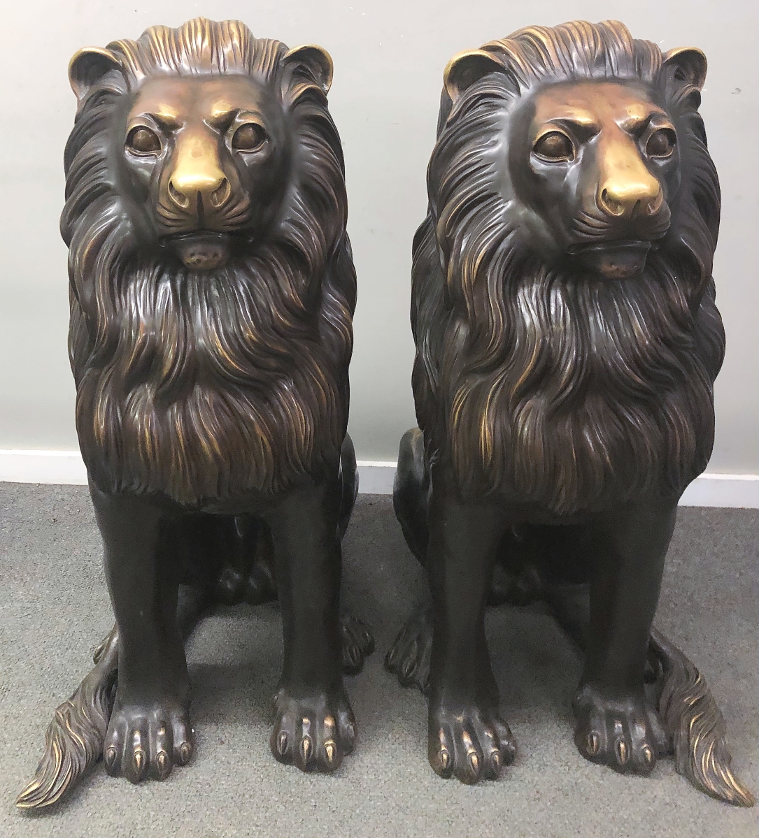 Auctioneer Tom Mattson tamed these bronze lions long enough for them to achieve $6,608.