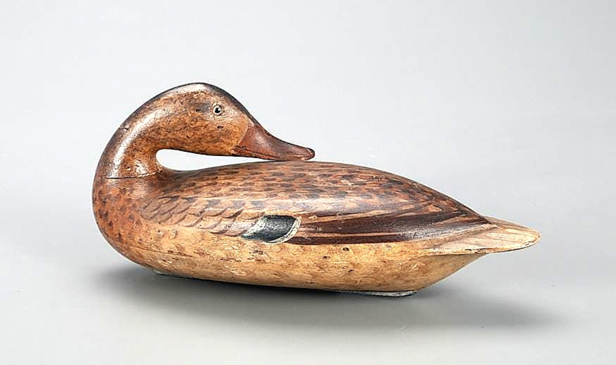 Carved by Robert Elliston and painted by his wife Catherine, this preening mallard hen earned $100,200. The decoy was extensively described and illustrated in Masterworks of The Illinois River and was included in a 2005 exhibition of those decoys.