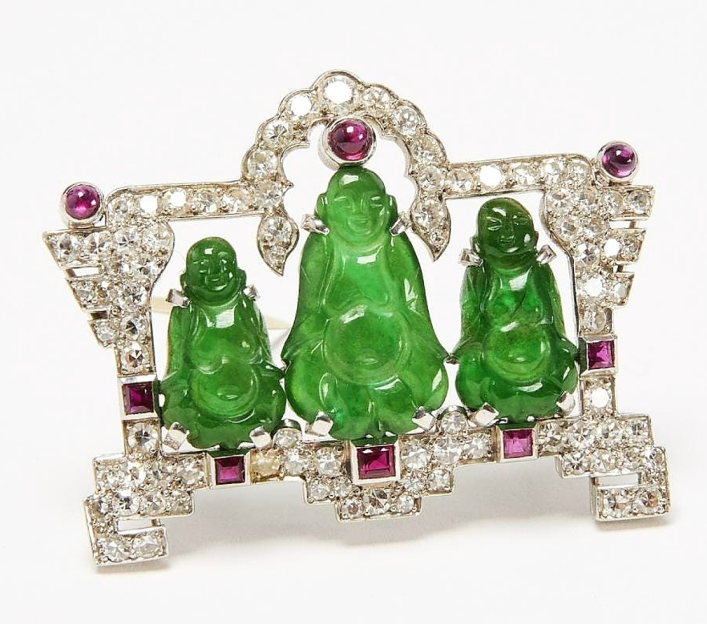 The three green jadeite Buddhas in this Cartier Art Deco diamond, rubies and jade brooch were obviously auspicious, as the brooch fetched $50,000 against a $3/6,000 expectation.