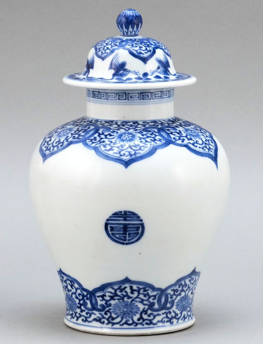 The sale was led by this Chinese blue and white porcelain covered jar, which brought $200,000, selling online. The unusually decorated Nineteenth Century piece in temple jar form had Shou decoration about the body and lotus-filled lappets at shoulder and foot. With domed cover with floral knop, and crane, wave and lappet decoration, the 9-inch-high jar had a six-character Kangxi mark on its base.