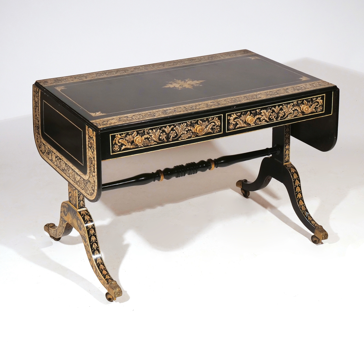A private New Rochelle, N.Y., collection contributed this early Nineteenth Century English regency sofa table, its black ebonized ground decorated with ornate overall pen work. With two drawers and two frieze drawers, splayed legs with brass caps and casters, it took $28,060.