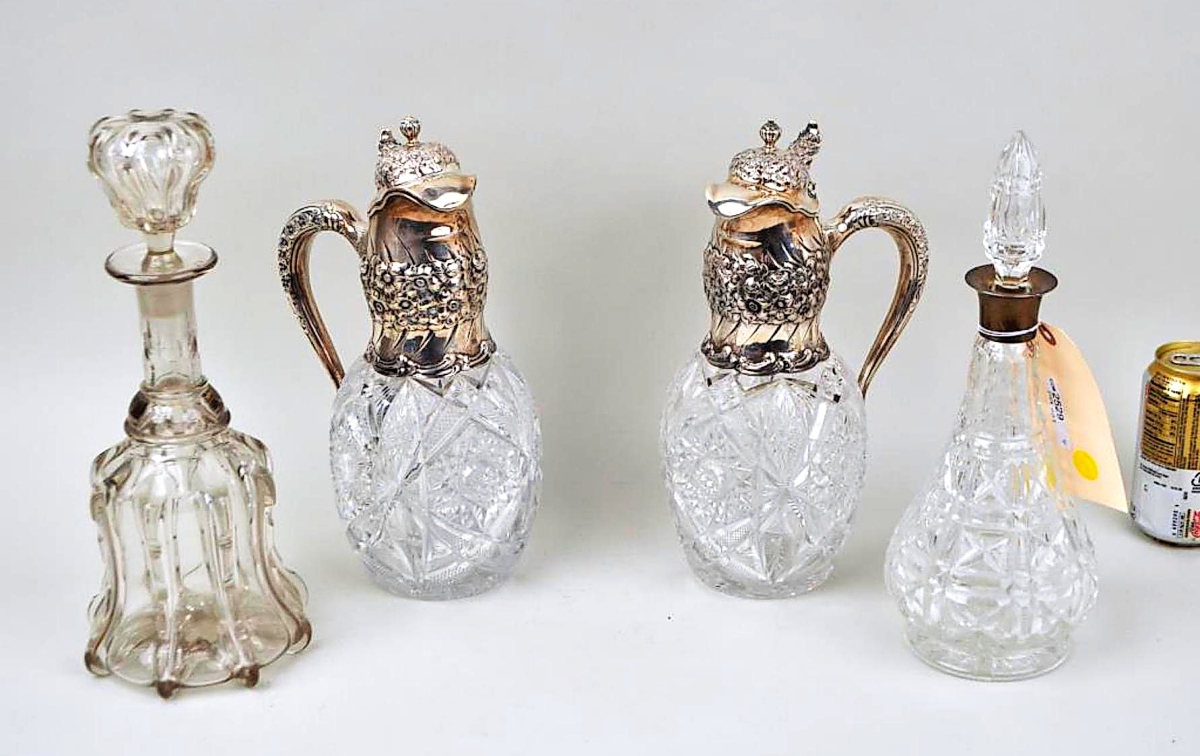 The market for cut glass has seen stronger days but ones with sterling mounts can still bring a hefty price. That was demonstrated by a pair of wine ewers with mounts marked “CW Schumann & Sons;” the pair was grouped with two glass decanters. The entire lot brought $9,760 from a phone bidder ($200/300).