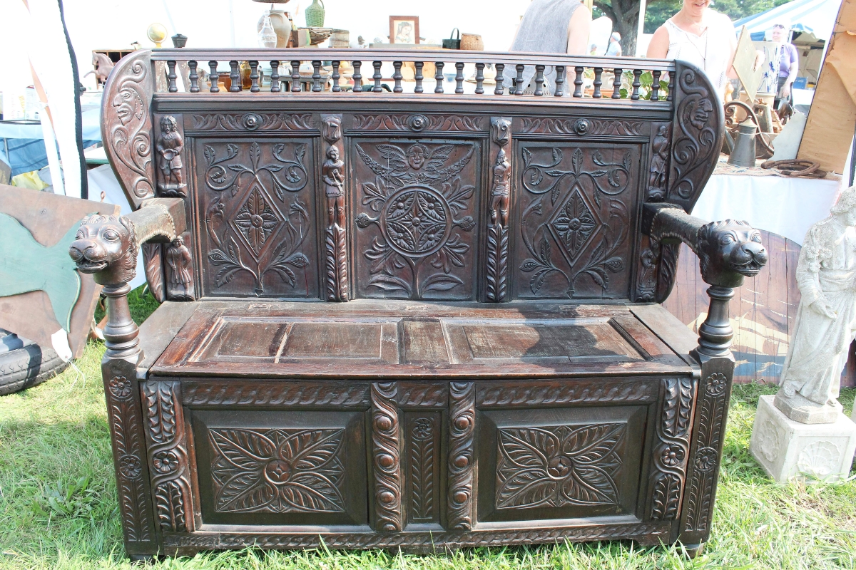 An antique English oak chest with great carving and made in 1712 was being offered by Mat King, Marshfield, Mass. It bore an inscription by the maker “L. Dermenn Seail.”   —Brimfield Auction Acres