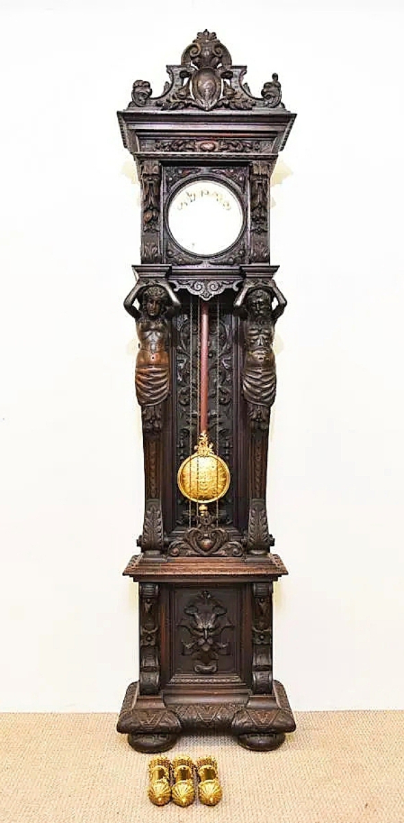 Under the five-figure sums of the cars, this German eight-day clock sold the next highest at $3,437. It featured elaborate carving with full-figured caryatids.