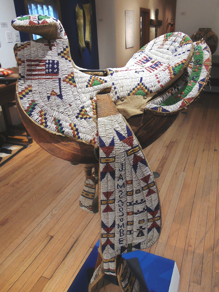 Lakota beaded child’s saddle, circa 1890, fully beaded over Western saddle with American flags and classic geometric elements, fully beaded stirrups and saddle cinch, offered by Morning Star Gallery, Santa Fe, for $120,000.