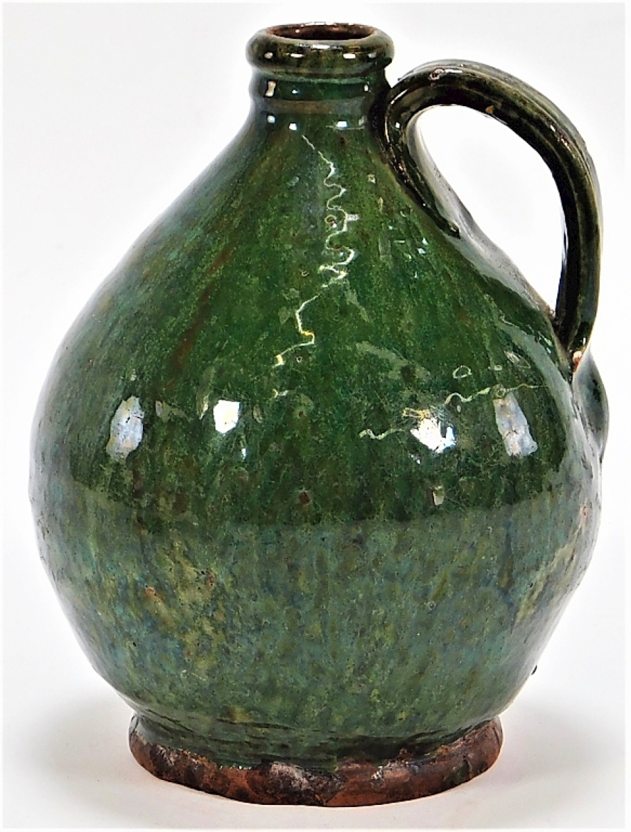 A surprise at the auction was this small 20th century American stubby handle jug with translucent cucumber green glaze.  About 7 by 5¾ inches, it was offered at $7,500, having only been offered with an estimate of $200/300.