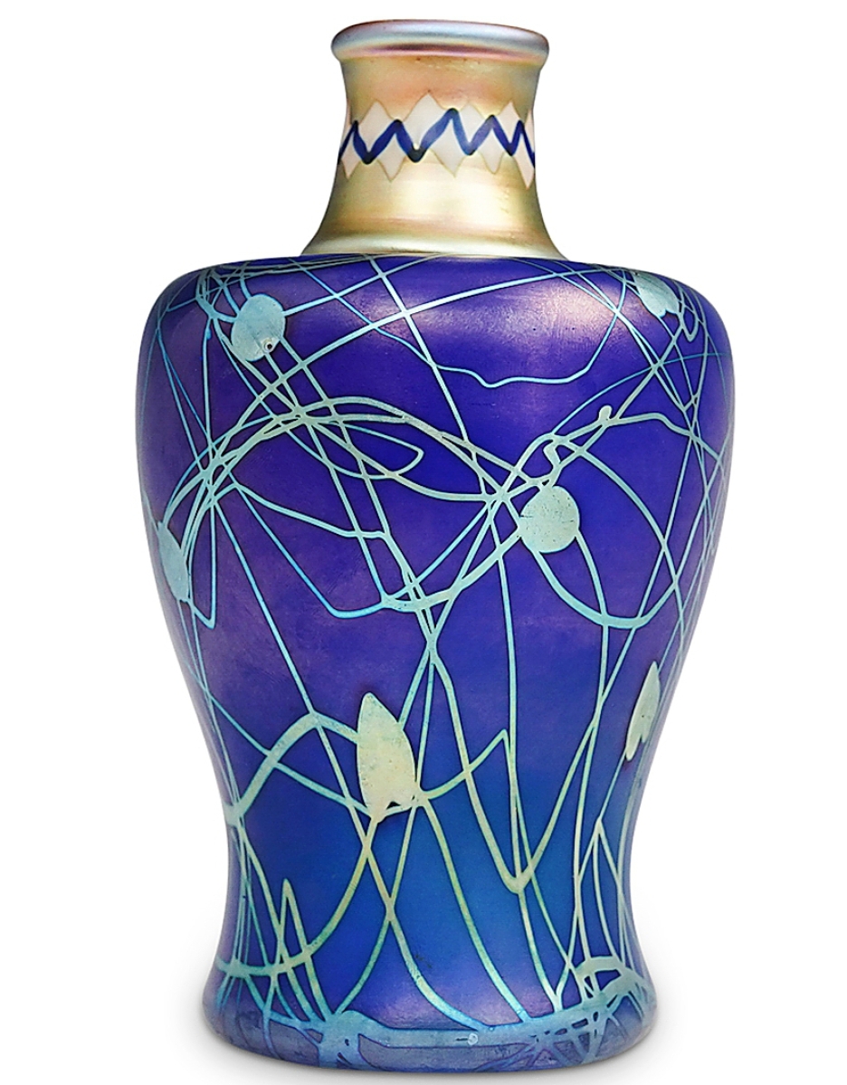 An example of Frederick Carder’s “Tiffany Blue,” this rare Steuben iridized sapphire blue vase was taken by 27 bids to $31,250 from a low $2,000 estimate. Circa early 1900s, the vase’s iridized sapphire blue over flint white was decorated with gold aurene leaf-and-vine and an intarsia collar.