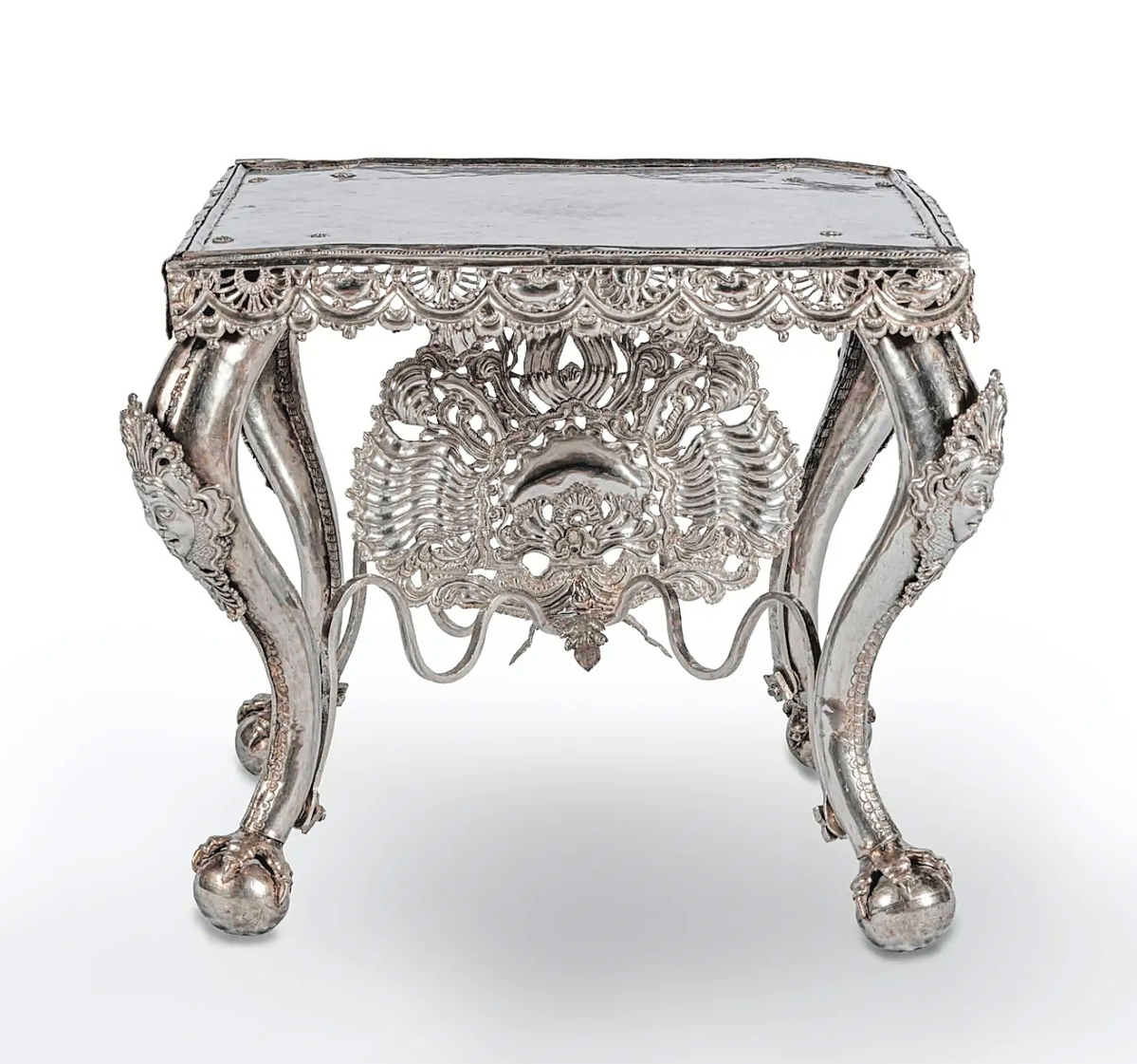 A silver estrado table from Upper Peru,   Eighteenth Century. Cast, hammered,   beaten and chased, 15 inches high.