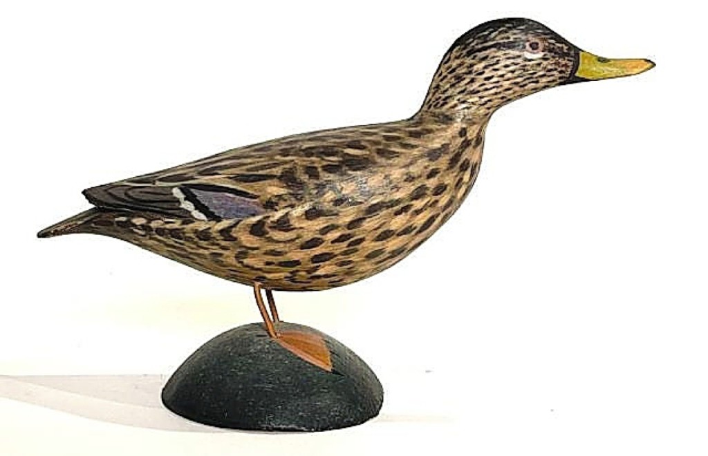 Setting a new record for an Elmer Crowell miniature was a mallard hen that brought $9,840. Crowell depicted this hen in a rare forward pose, and it bore his blue paper label on the base. Its mate, a mallard drake, earned $1,599.