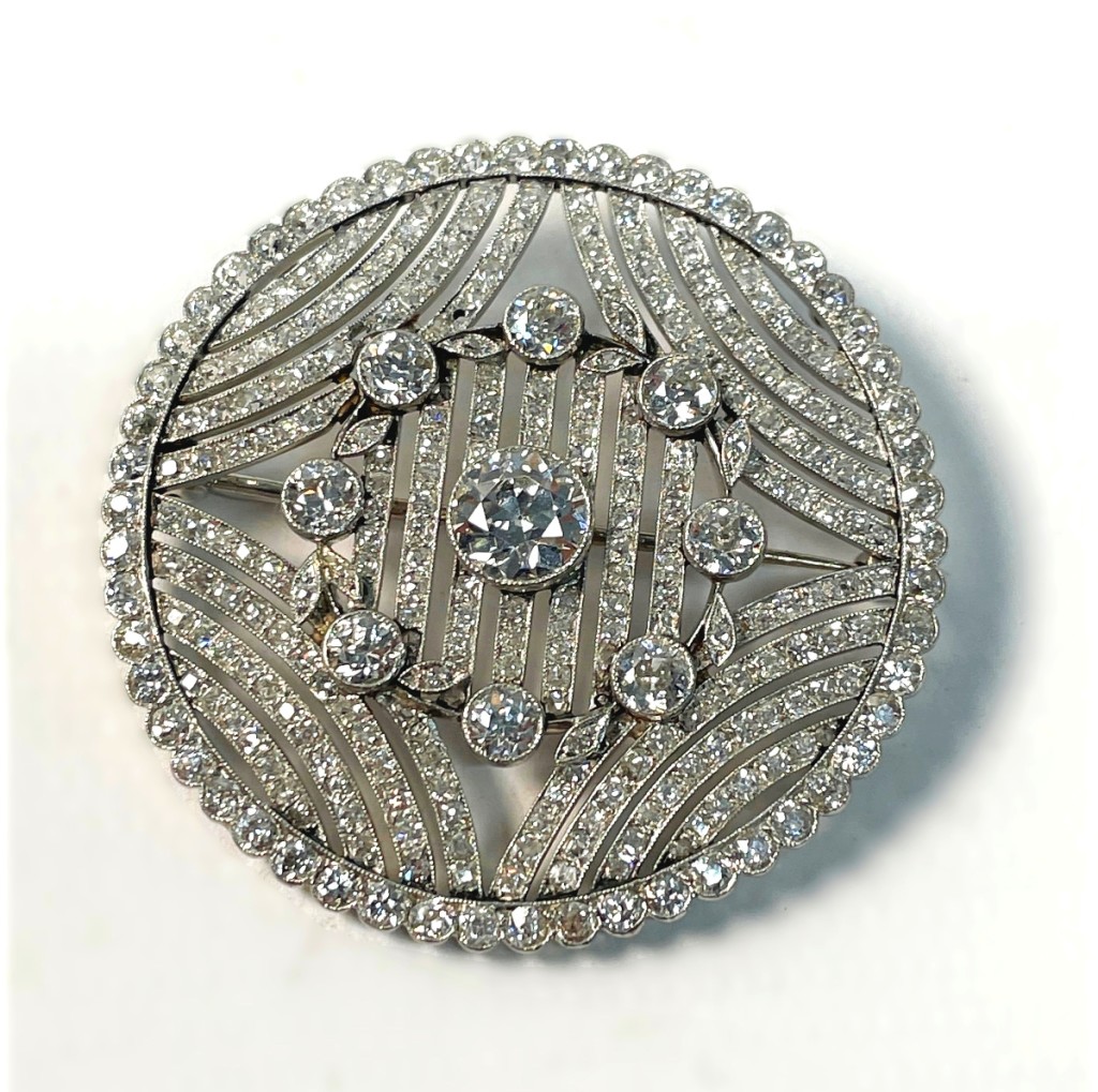 The circular diamond brooch, approximately 8.5 total carat weight with stones set in platinum, commanded $10,000.