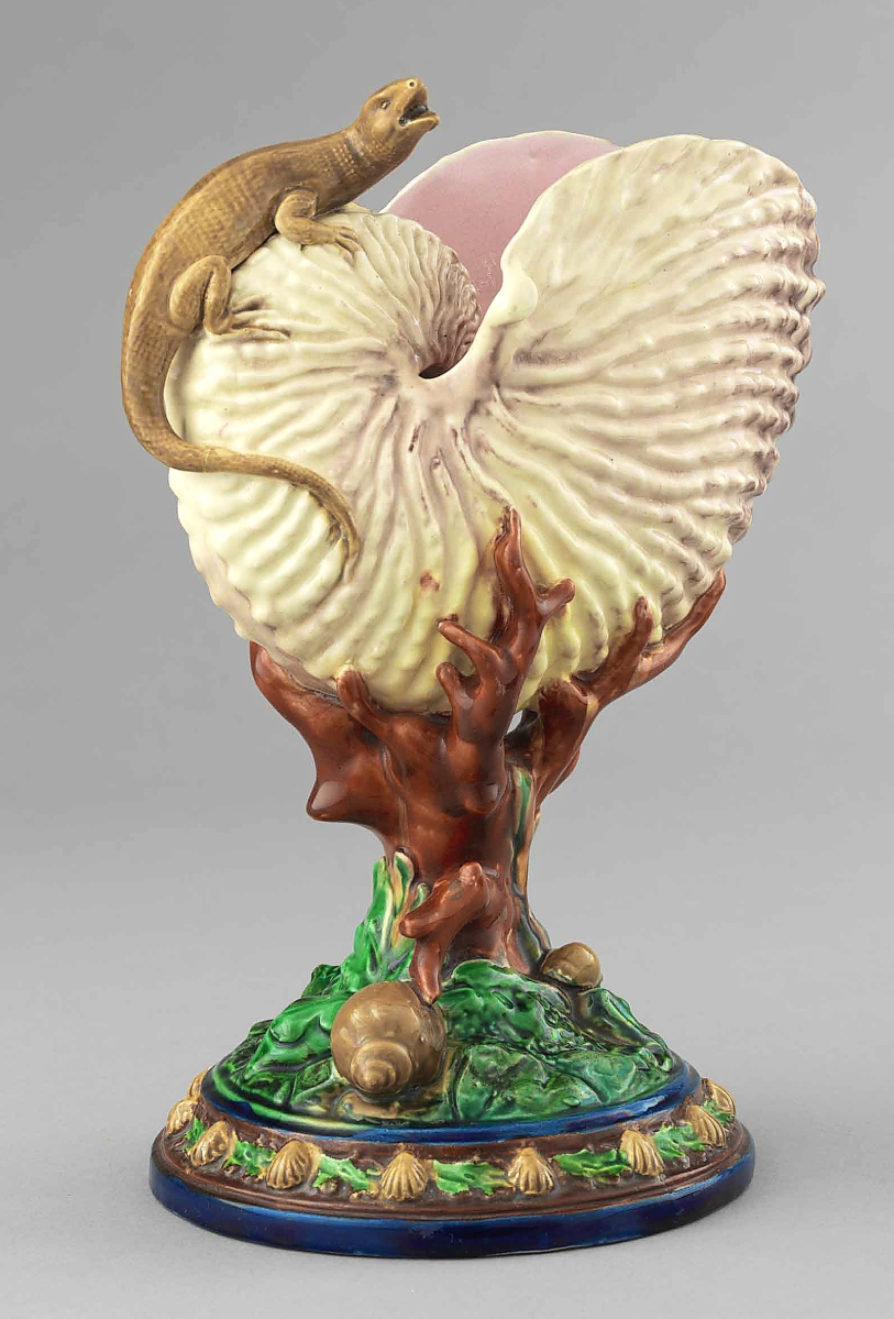 During the Renaissance era, skilled artisans embellished rare natural-history specimens with mounts of precious materials. This object evokes a nautilus cup of the Sixteenth Century. Nautilus shell with lizard by Worcester Royal Porcelain Co., circa 1870. Earthenware with majolica glazes, 9¼ by 6-  by 6 inches. Collection of Marilyn and Edward Flower. Photograph Bruce White.