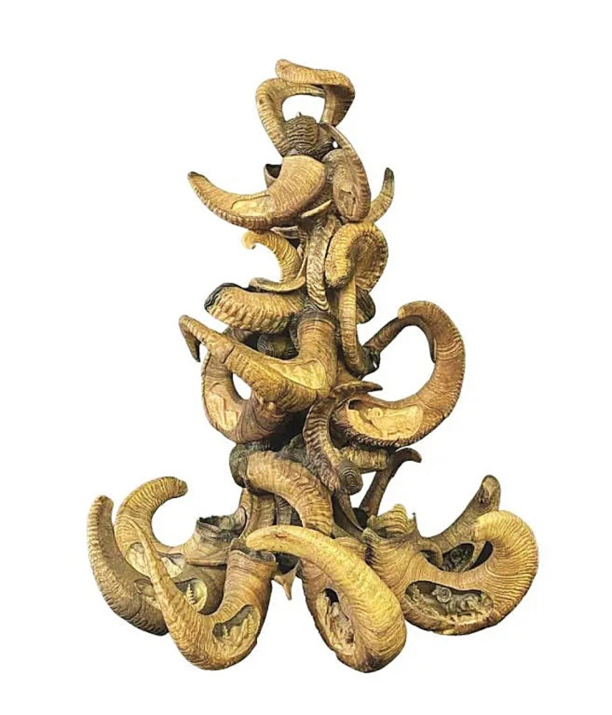 Look closer. Carved into each of the 24 ram’s horns is a relief scene of Bighorn, Dall, Stone and Desert sheep. The 44-inch-tall chandelier was made by Kentucky artist Dan MacPhail and it sold for $16,200.