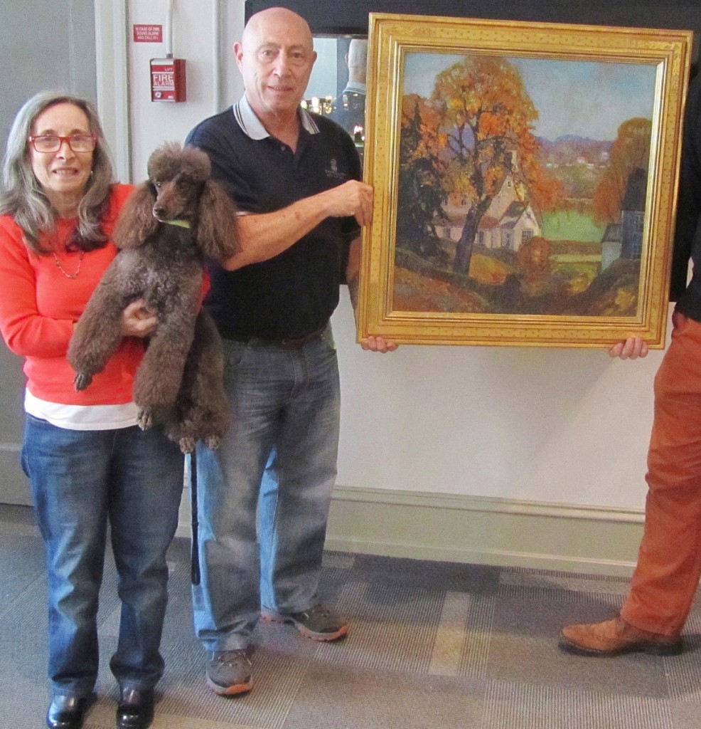 Sue and Les Fox with their miniature poodle, Bruno,   holding a Coppedge painting.