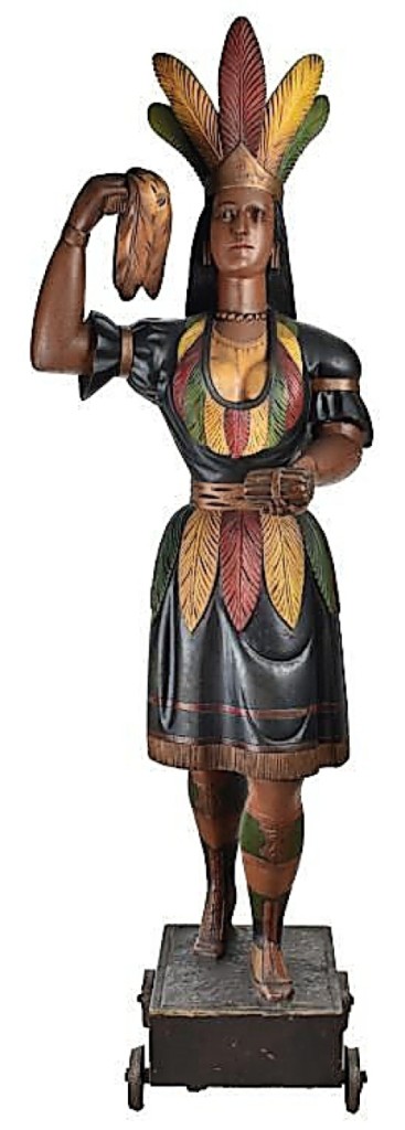 At $570,000, the undisputed star of the sale was this 83-inch-tall cigar store Indian princess with a well-documented provenance. It had stood in front of a store in Louisville, Ky., for perhaps a hundred years before being sold in 1974. The catalog, which devotes six pages to her, has a great deal of information on the carving and speculates that it may have been made by Samuel Robb or Thomas Brooks. The cigar store princess is shown standing in front of this Louisville, Ky., store.